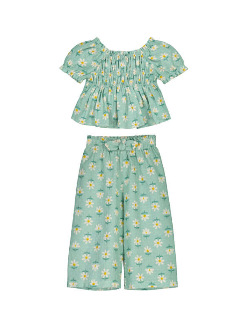 Girls Children's summer outfit with floral top and pants on a white background