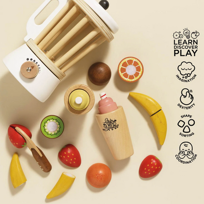 Wooden toy kitchen set with fruits and kitchen tools on a beige background, featuring 'Learn Discover Play' logos. FRUIT & SMOOTHIE WOODEN TOY BLENDER SET | LE TOY VAN