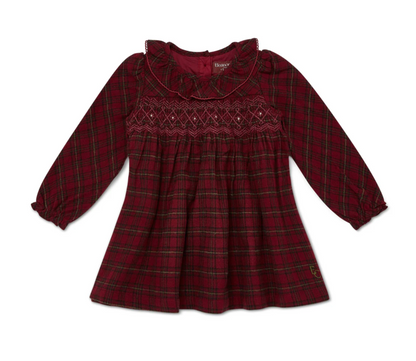 Eleanor Charles girls classic red tartan smock dress laid flat on a white background; full dress view showing deep crimson and forest green tartan fabric with fine gold metallic thread running through the weave; wide ruffled frill collar in plain crimson fabric with picot scallop trim along the outer edge; hand-smocked chest yoke with diamond lattice pattern in deep burgundy thread visible below the collar; long sleeves gathered at the shoulder with elasticated ruched cuffs and fine ruffle trim; fully gathe