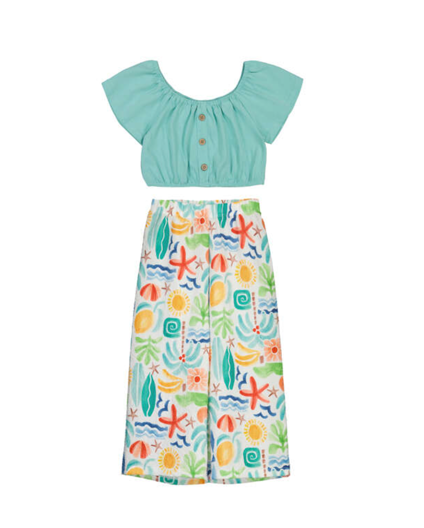 Girls Mayoral Two-piece outfit with a light blue top and colourful tropical trousers on a white background