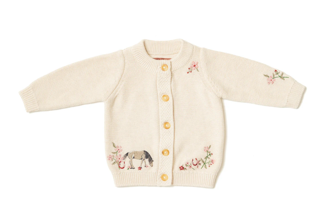 Knitted baby cardigan with embroidered designs. GIRLS ORGANIC COTTON HORSE SHOW FLORAL CARDIGAN | ELEANOR CHARLES