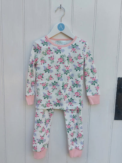 Floral pajama set with pink accents on a white wooden background. GIRL'S ENGLISH GARDEN FLOWER COTTON TOP & BOTTOM PYJAMAS - 3 SIZES | POWELL CRAFT