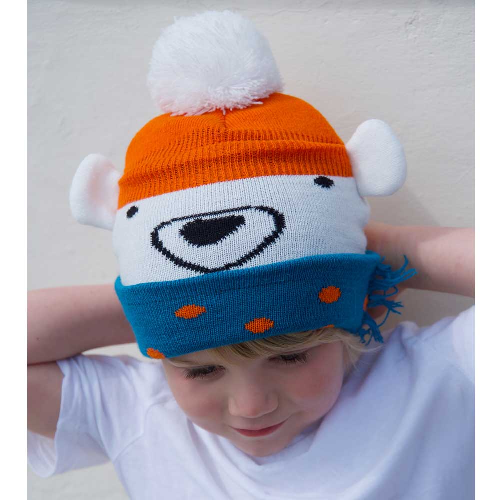 Child wearing a colorful knit hat with bear design. KID'S POLAR BEAR KNITTED HAT WITH POM-POM | POWELL CRAFT