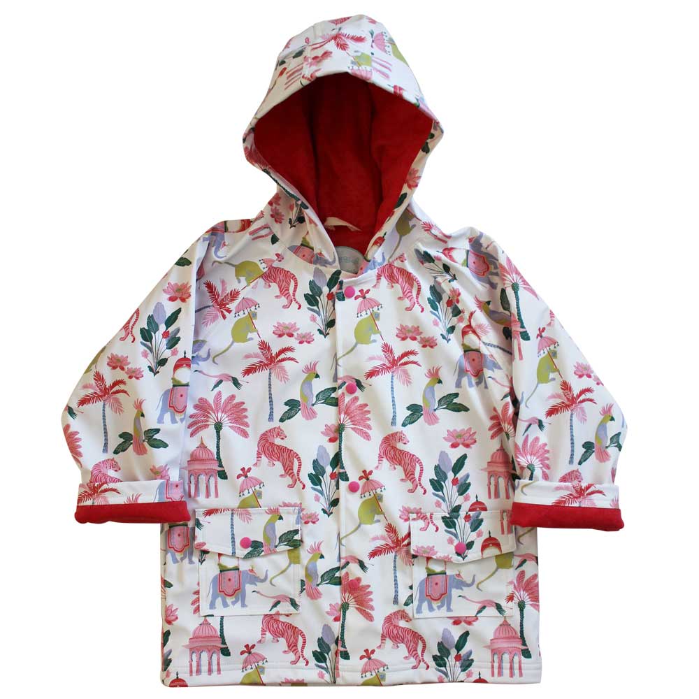 A hooded raincoat with a paradise garden print featuring animals such as tigers, elephants, and monkeys, and plants like palms and lotus flowers, predominantly in white with red lining and multicolored print. KID'S SULTAN'S GARDEN LINED RAINCOAT - 3 SIZES | POWELL CRAFT