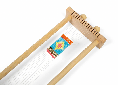 Small wooden loom with colorful woven pattern. KID'S WOODEN BEAD WEAVING LOOM | BIGJIGS