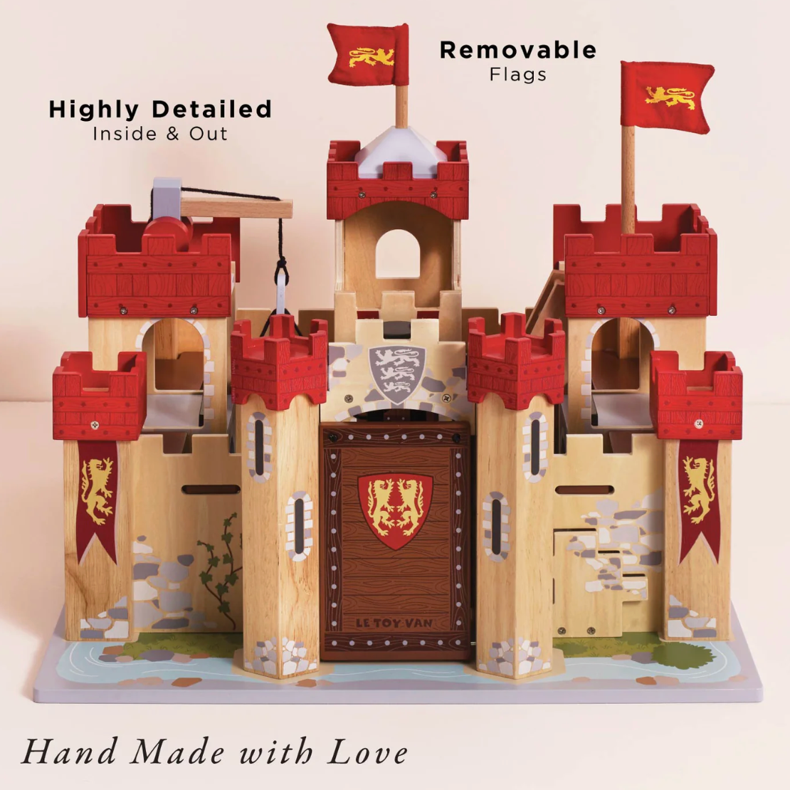 Wooden toy castle with removable flags and visible branding on a light background. LIONHEART WOODEN TOY CASTLE | LE TOY VAN
