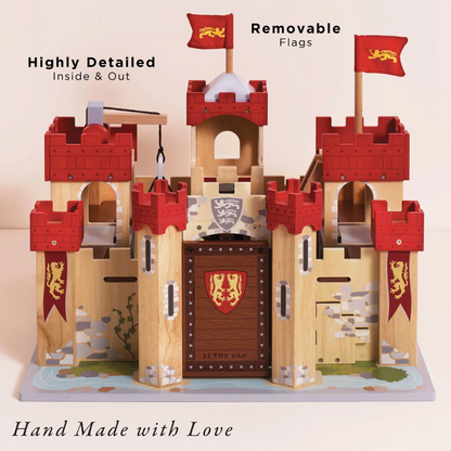 Wooden toy castle with removable flags and visible branding on a light background. LIONHEART WOODEN TOY CASTLE | LE TOY VAN