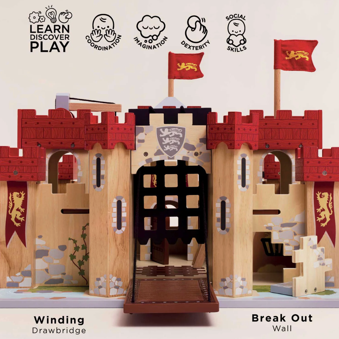 Wooden toy castle with drawbridge and flags, labeled 'Learn Discover Play' on a white background. LIONHEART WOODEN TOY CASTLE | LE TOY VAN