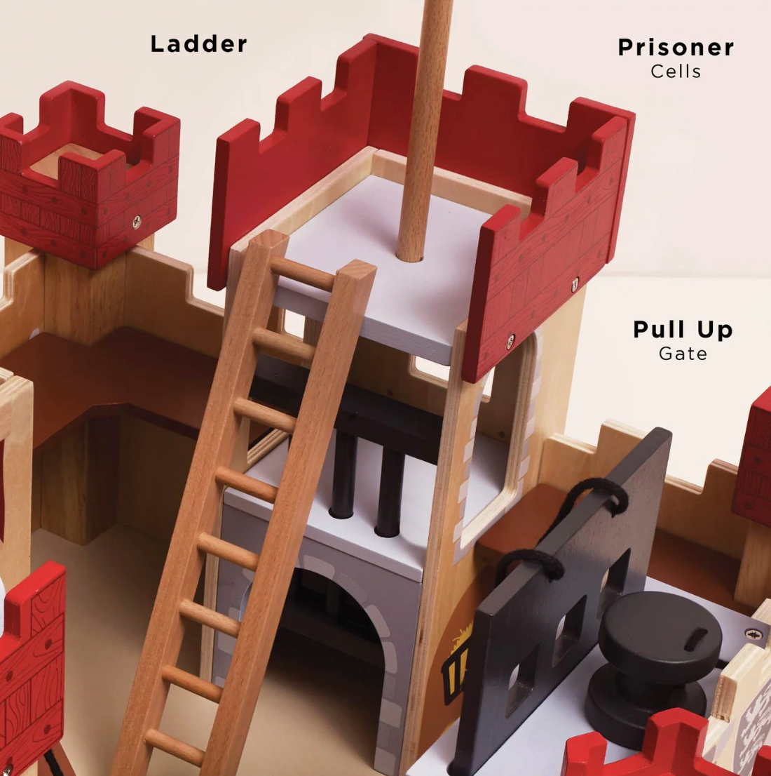 Wooden playset with labeled components including a ladder, pull-up gate, and prisoner cells. LIONHEART WOODEN TOY CASTLE | LE TOY VAN
