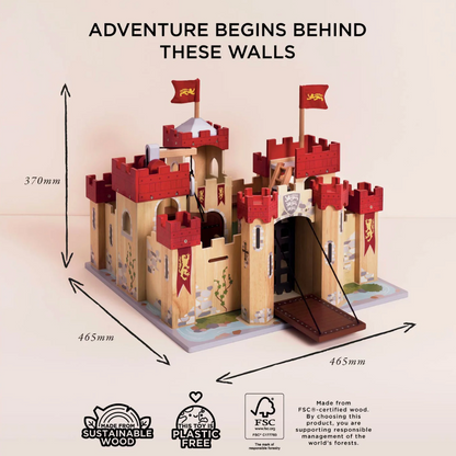 Wooden castle model with red towers and flags, dimensions indicated, on a light background. LIONHEART WOODEN TOY CASTLE | LE TOY VAN