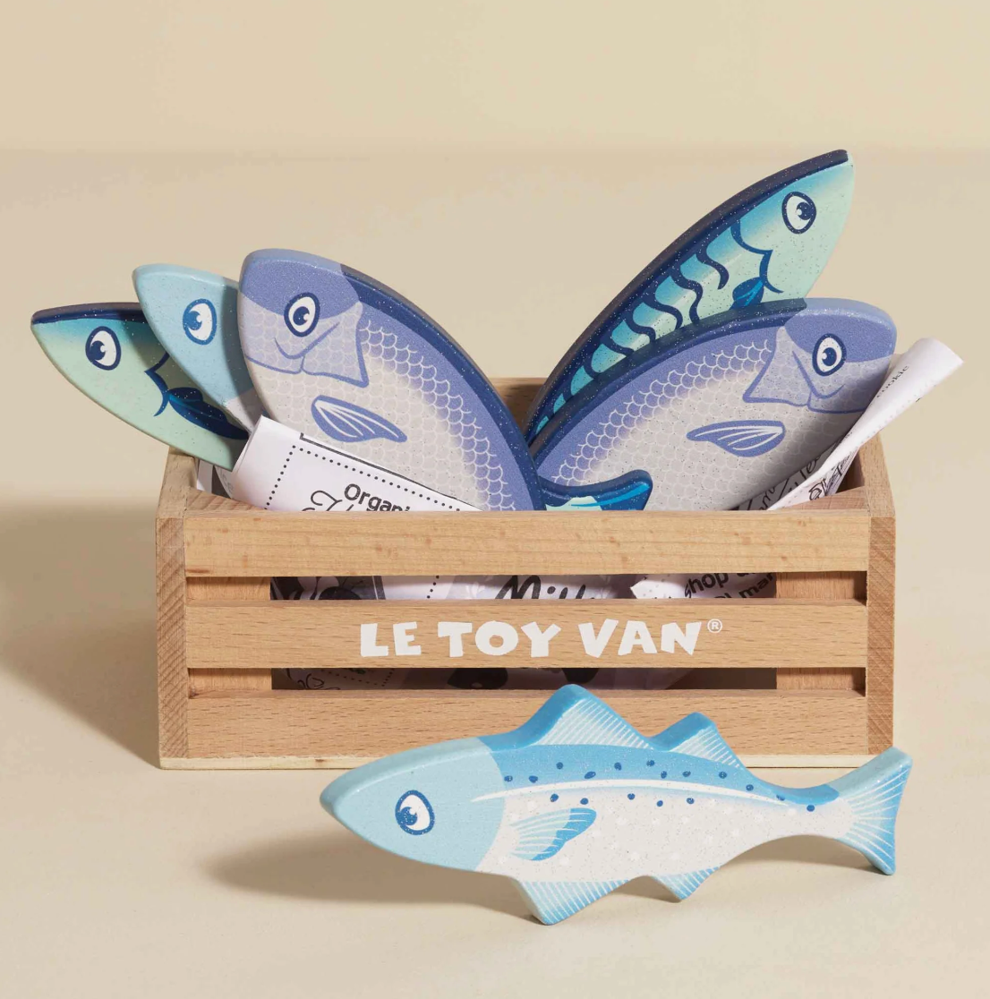 Set of toy fish in a wooden crate with 'Le Toy Van' branding on a beige background. MARKET FISH WOODEN TOY CRATE | LE TOY VAN