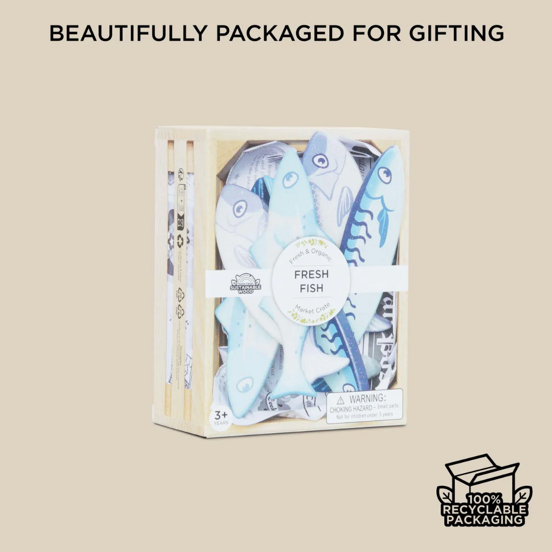 Packaged toy fish set with 'Fresh Fish' label and recycling logo on beige background MARKET FISH WOODEN TOY CRATE | LE TOY VAN
