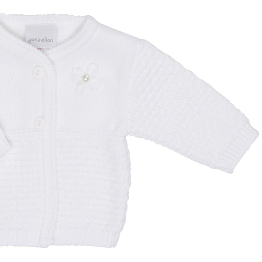 White baby cardigan with buttons on a white background. MATINEE BABY GIRL KNIT CARDIGAN WITH PEARL FLOWER - WHITE | DANDELION
