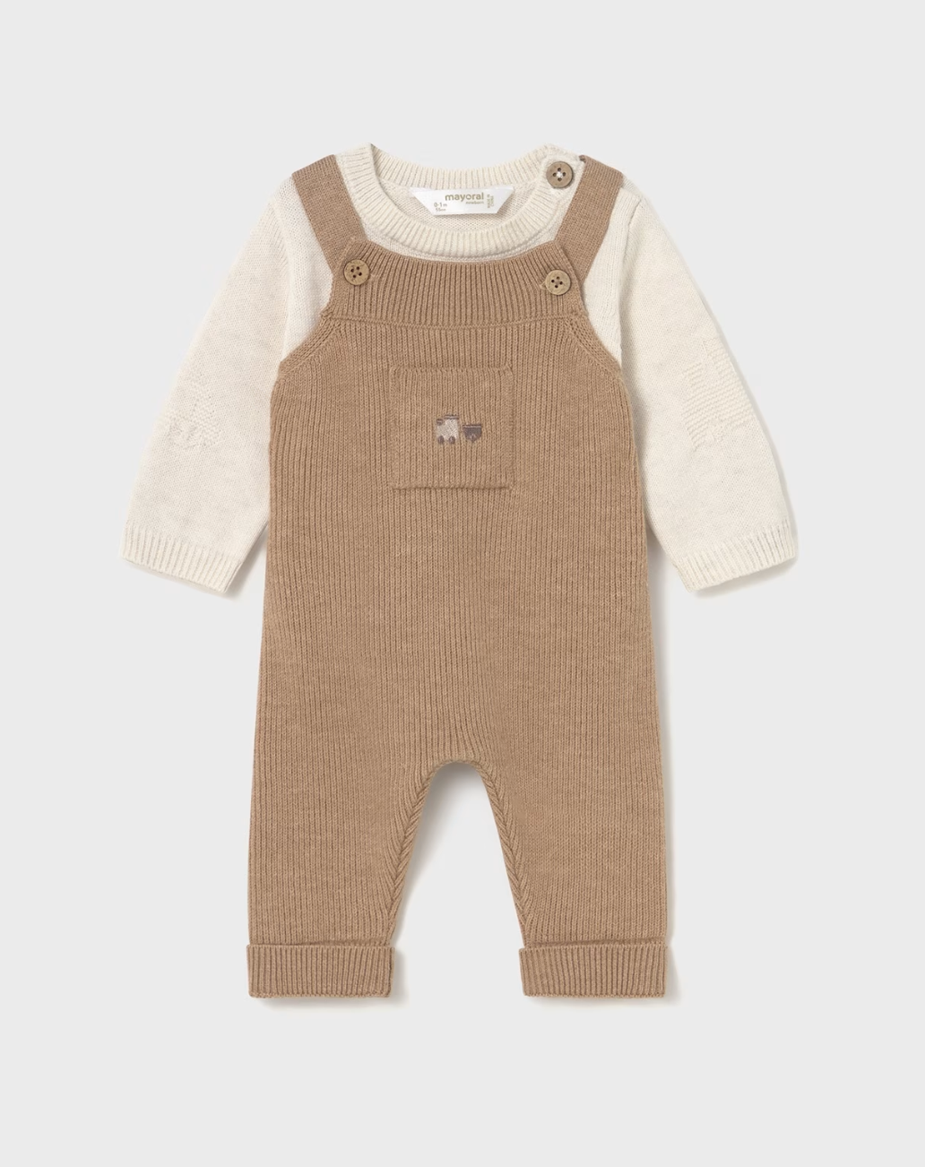 Mayoral baby 2-piece knit set in toffee — front flat lay showing toffee caramel fine ribbed dungarees with two wooden buttons at the bib, small chest pocket with tiny embroidered bear motif, and ribbed turn-up cuffs; layered over cream fine knit sweater with subtle textured sleeve pattern and single wooden button shoulder opening; Mayoral label visible at the back neck