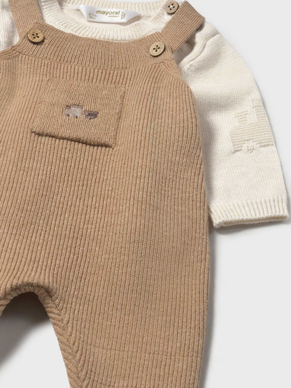Mayoral baby 2-piece knit set in toffee — close-up of the upper front showing the toffee ribbed dungaree bib with two wooden buttons, small chest pocket with tiny embroidered bear motif, and the cream fine knit sweater with subtle textured sleeve pattern and Mayoral label at the neck