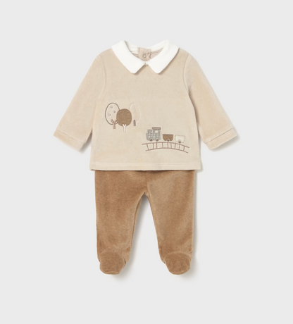 Mayoral Baby Cosy Jumper and Footed Trouser Set in Toffee — front ghost flat-lay on light grey background; two-piece velour baby outfit; cream/oat velour long-sleeve jumper with white Peter Pan collar at the neckline; embroidered and appliqué steam train scene on the front showing a little steam train on a railway track with two carriages and two round-topped trees in taupe, grey-blue and cream tones; long sleeves with turned-back cuffs; warm toffee/caramel velour footed trousers with integrated feet; light