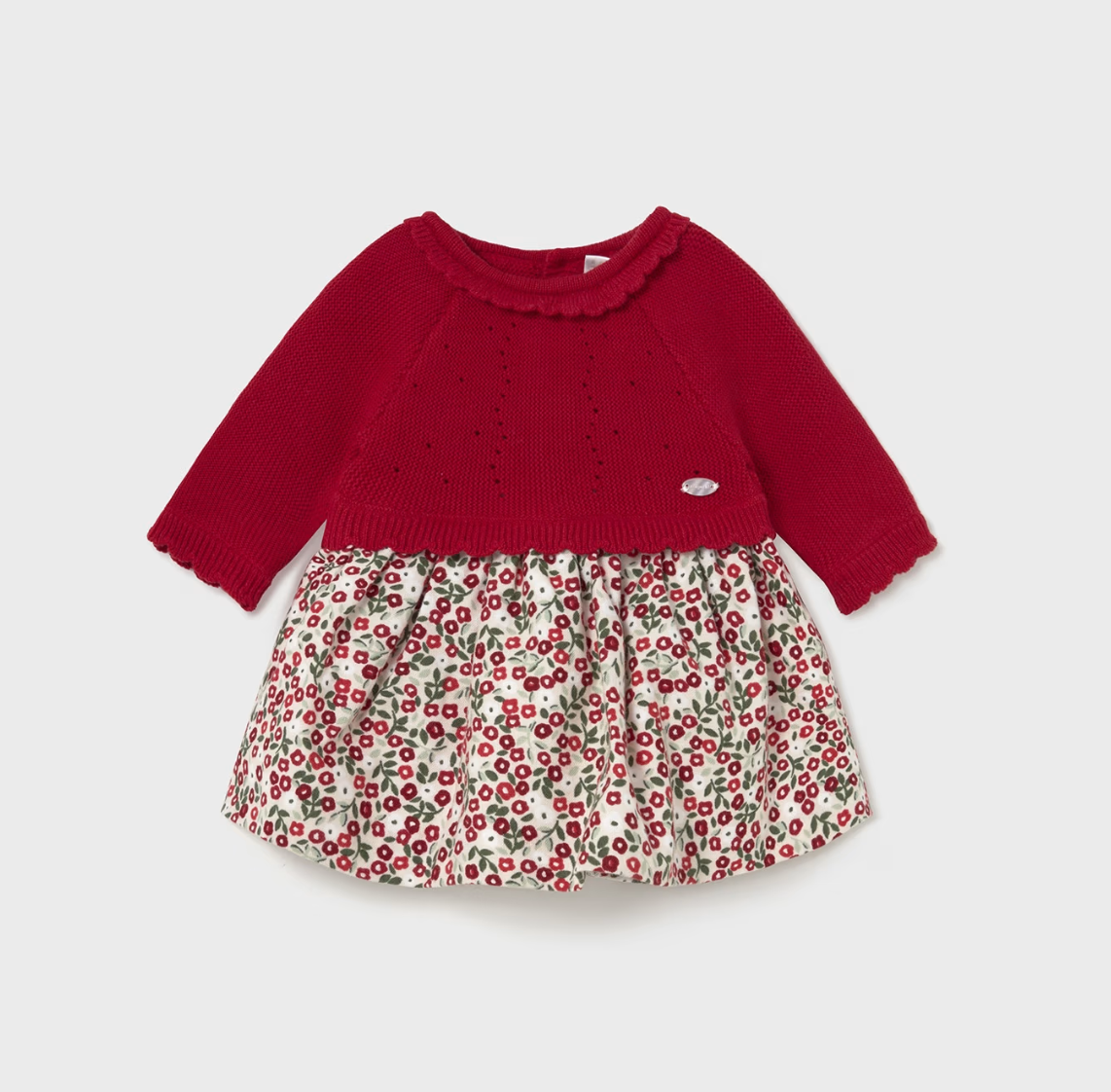 Front flat — cherry red knit bodice; scalloped neckline; pointelle detail; silver Mayoral badge; cream floral skirt with ditsy cherry blossom print. 