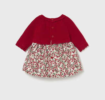 ack flat — 3 red buttons down centre back; scalloped neckline visible; floral skirt back; scalloped ribbed cuffs. 