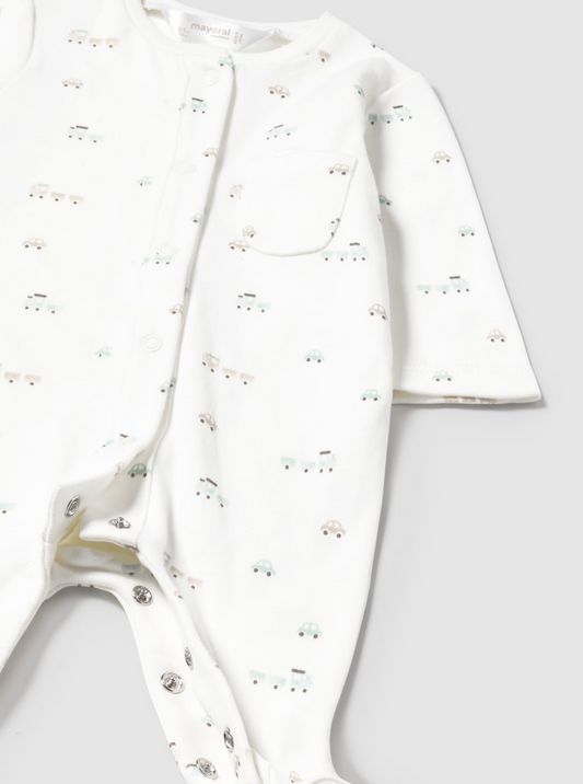 White baby outfit with subtle NEUTRAL TRAIN pattern 