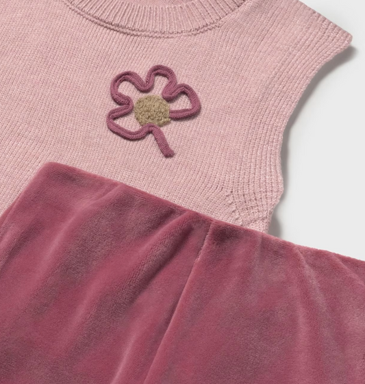 Close-up — cord flower appliqué detail; velour trouser fabric; knit texture contrast.