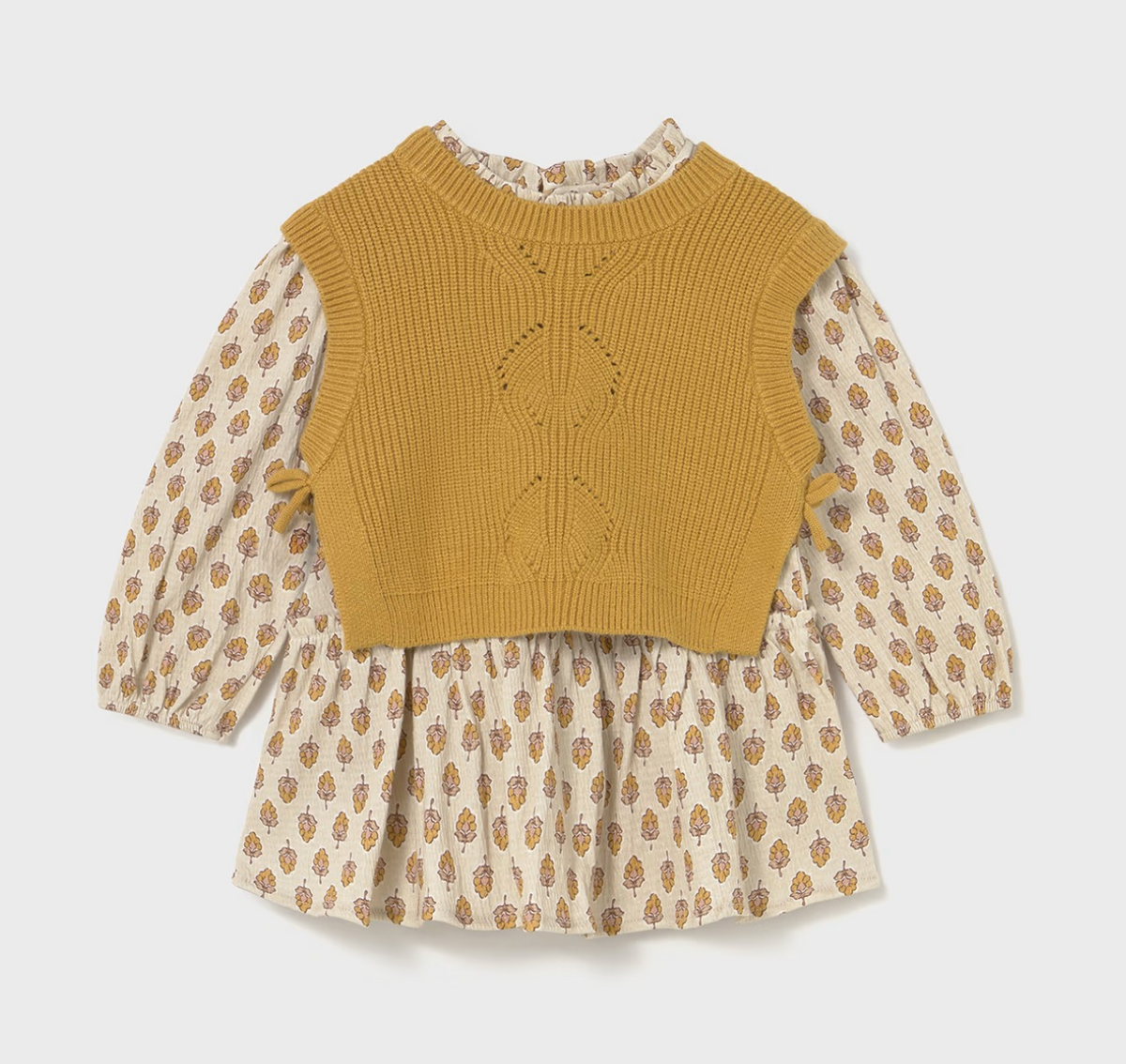 Front ghost flat-lay — vest over dress; ditsy floral posy print on sleeves and skirt; diamond eyelet panel; ruffle neckline and side tabs.