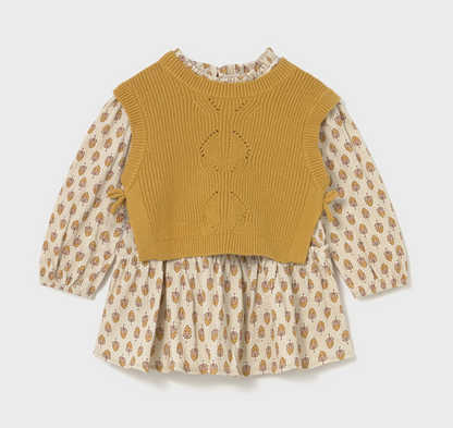 Front ghost flat-lay — vest over dress; ditsy floral posy print on sleeves and skirt; diamond eyelet panel; ruffle neckline and side tabs.