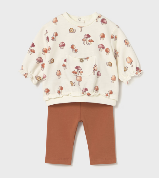 Front flat-lay — cream sweatshirt with full mushroom and snail print; scalloped hem and cuffs; wooden button pocket; snap poppers at back neck; terracotta leggings.