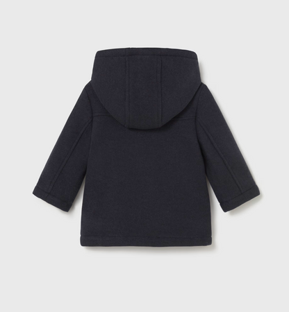 Back ghost-lay — plain navy back; structured hood; quilted sleeve panels; A-line length.