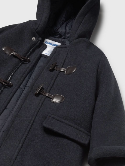 Close-up — toggle construction detail; leather D-rings; braided cord loops; concealed zip; Mayoral label; quilted lining.