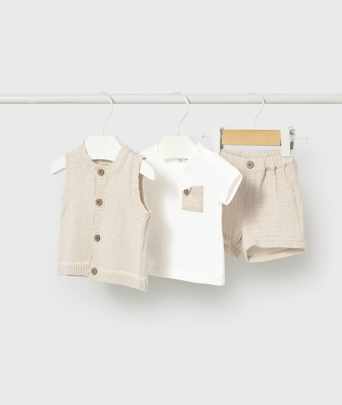 Children's clothing set with vest, shirt, and shorts on hangers. NEUTRAL BABY SHORTS WITH VEST AND T-SHIRT SET | MAYORAL