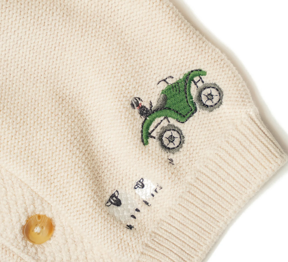 Embroidered design on a beige fabric WITH A QUAD BIKE AND SHEEP. ORGANIC COTTON ON THE FARM EMBROIDERED CARDIGAN | ELEANOR CHARLES