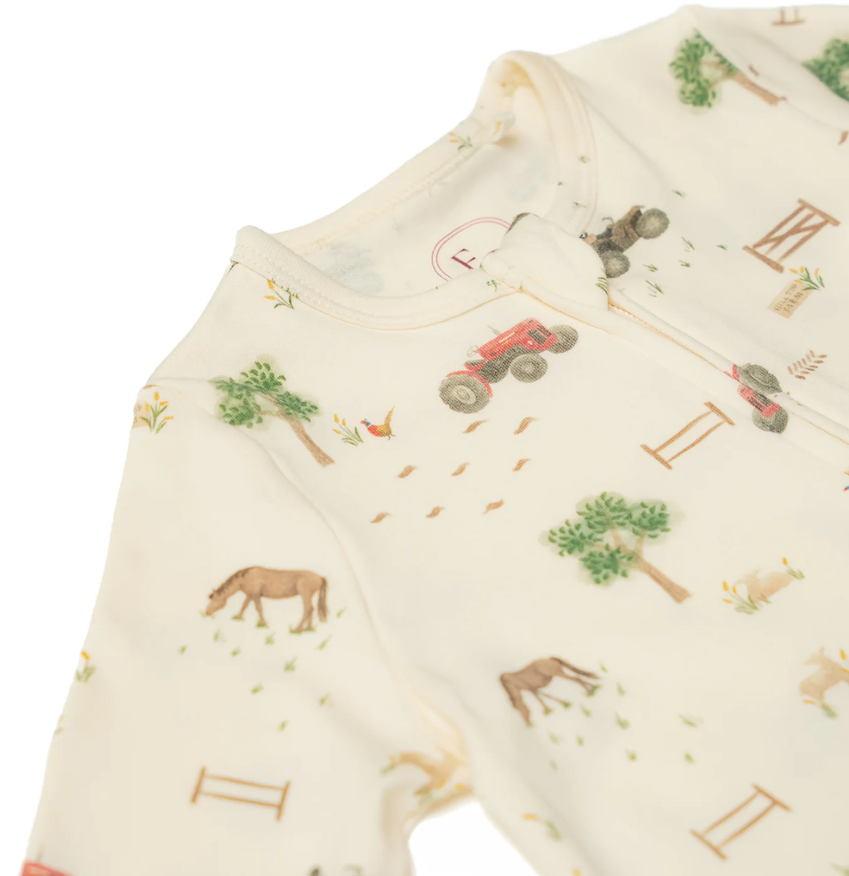 Baby romper with farm animal and tractor pattern. ORGANIC COTTON ZIP-UP BABY SLEEPSUIT FARM PRINT | ELEANOR CHARLES
