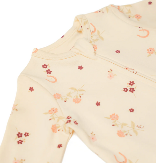 Close-up of a baby onesie with floral pattern on a white background. ORGANIC COTTON ZIP BABY SLEEPSUIT - HORSESHOE FLORAL