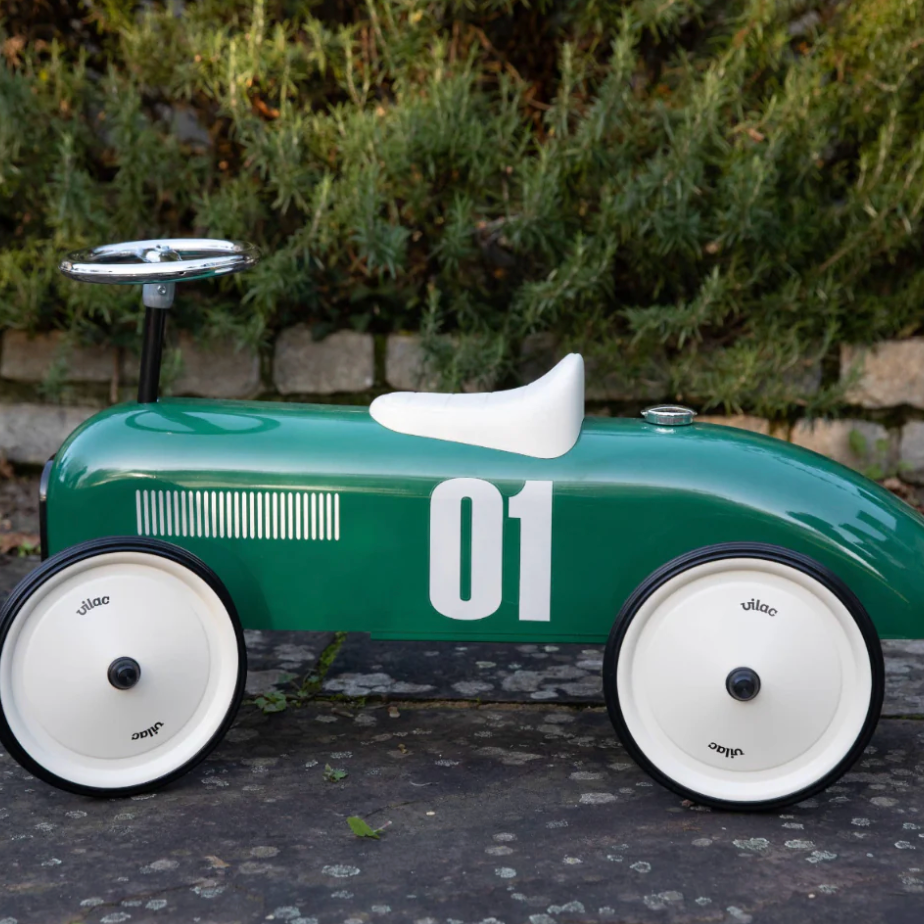 Green toy car with number 01 on a paved surface with greenery in the background. RIDE ON CLASSIC CAR - BRITISH RACING GREEN WITH WHITE SEAT | VILAC 
