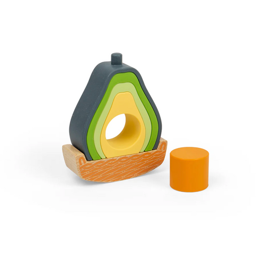 Wooden avocado toy with a slice taken out on a white background ROCKING AVOCADO TOY | BIGJIGS