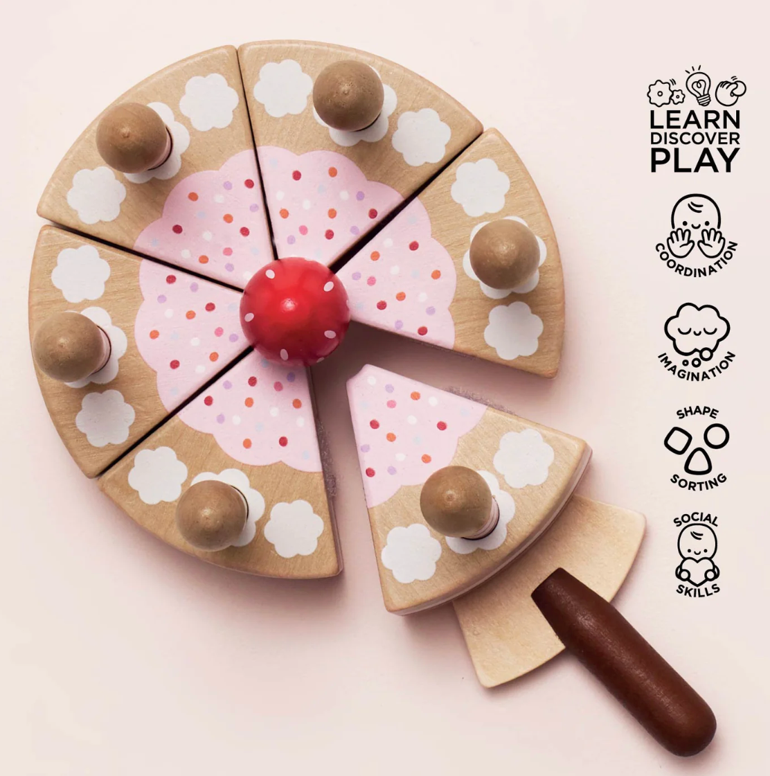 Wooden toy pizza with colorful toppings on a light pink background, featuring 'Learn Discover Play' branding. SLICEABLE TOY BIRTHDAY CAKE & CANDLES | LE TOY VAN