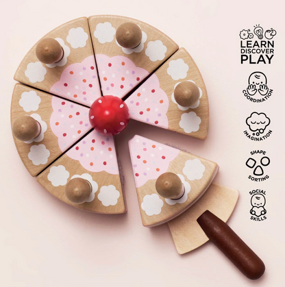 Wooden toy pizza with colorful toppings on a light pink background, featuring 'Learn Discover Play' branding. SLICEABLE TOY BIRTHDAY CAKE & CANDLES | LE TOY VAN