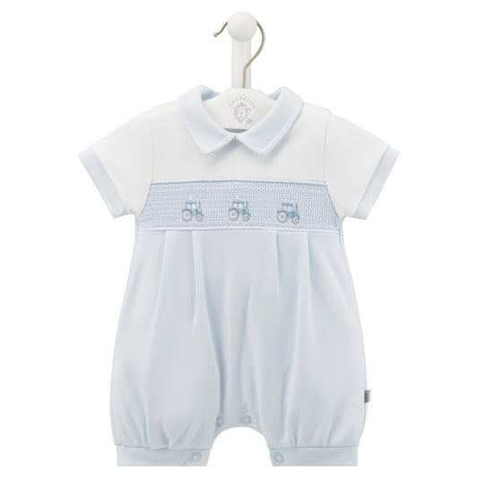 White baby romper with blue trim and embroidered details on a hanger. SMOCKED TRACTOR COTTON SUMMER ROMPER OUTFIT - BABY BLUE | DANDELION