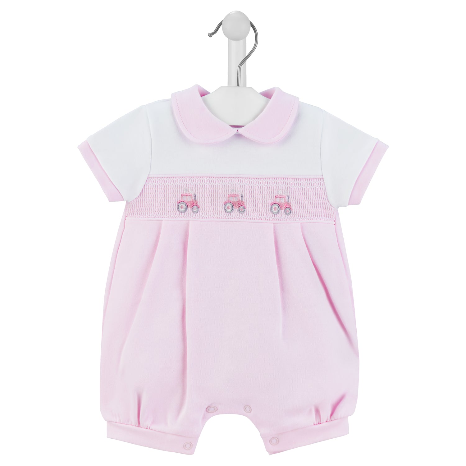 A pink short-sleeved romper with a Peter Pan collar and a smocked tractor design on the chest, displayed on a hanger. SMOCKED TRACTOR COTTON SUMMER ROMPER OUTFIT - BABY PINK | DANDELION