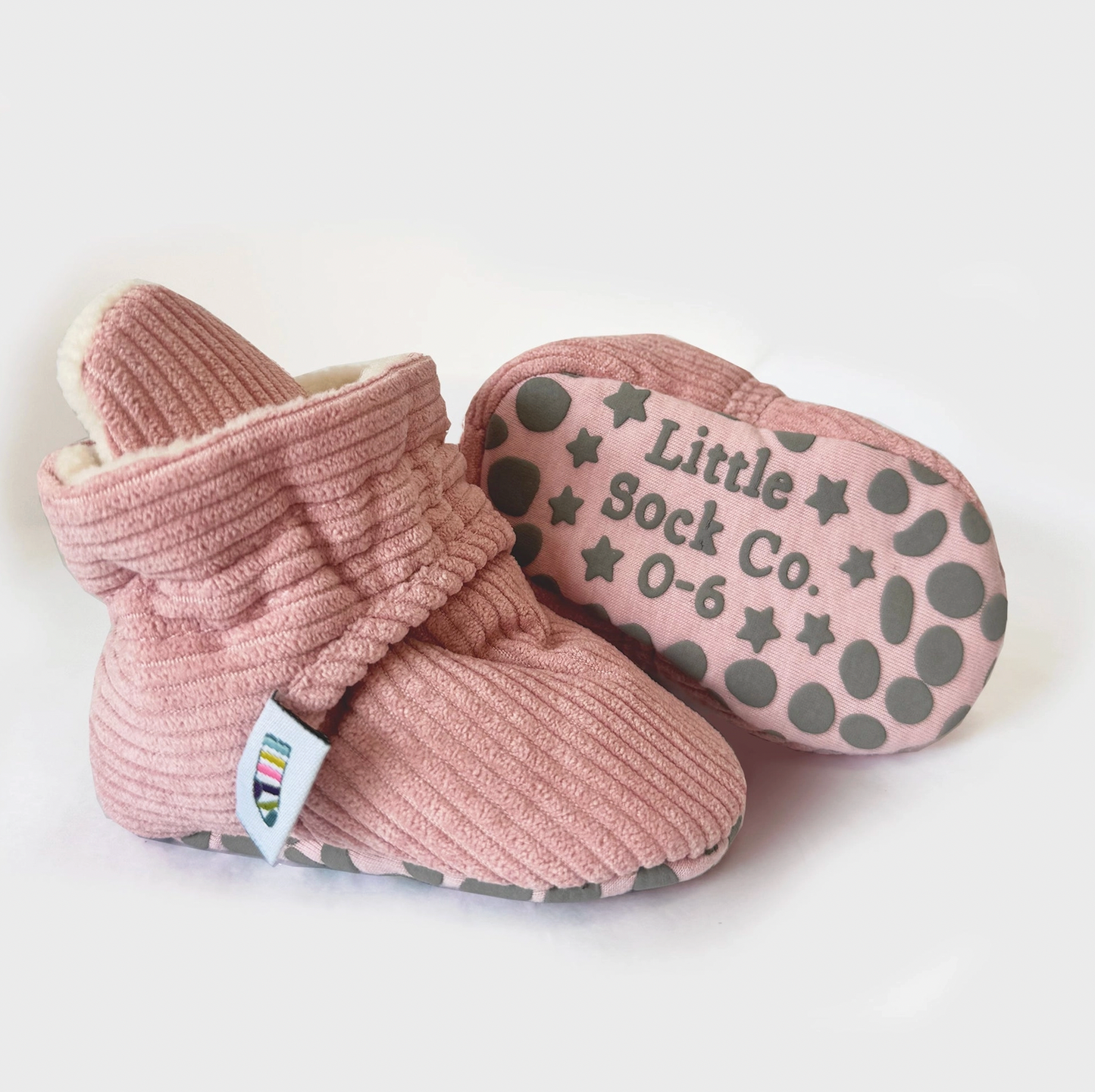 Pink baby booties with 'Little Sock Co.' branding on a white background STAY-ON, NON-SLIP BOOTIE - PINK CORDUROY | THE LITTLE SOCK CO.