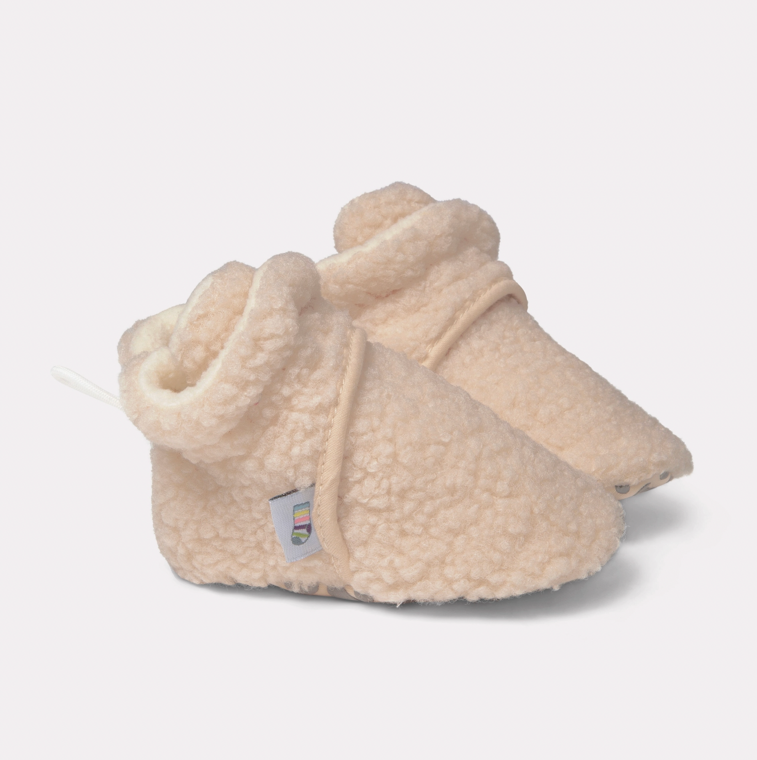 Pair of cream-colored baby booties with fleece texture on a light gray background STAY-ON, NON-SLIP BOOTIE - SHERPA | THE LITTLE SOCK CO.