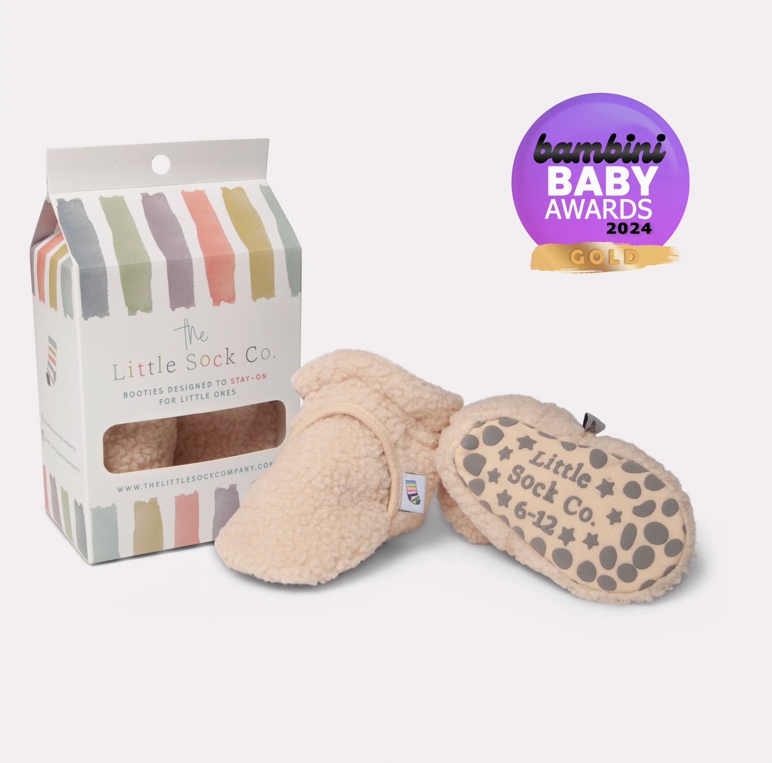 Beige baby booties with packaging and Bambini Baby Awards 2024 gold badge on a white background STAY-ON, NON-SLIP BOOTIE - SHERPA | THE LITTLE SOCK CO.