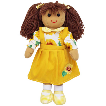 A brown-haired ragdoll wearing a yellow dress with a sunflower design, yellow gingham collar, and matching shoes. SUNFLOWER RAGDOLL WITH BROWN HAIR AND PINAFORE DRESS | POWELL CRAFT