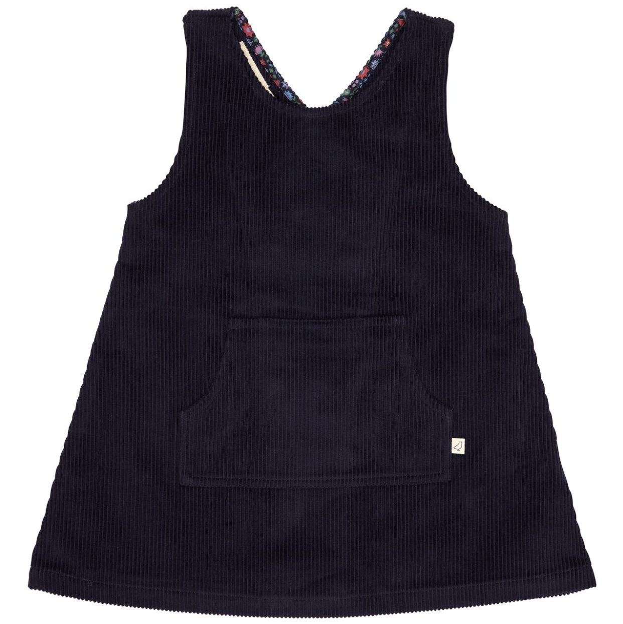 A sleeveless dark navy corduroy pinafore dress with a front patch pocket and a small white brand tag on the lower right hem, shown against a plain white background.