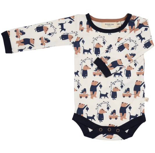 Pigeon Organics Animal Procession long-sleeved baby body in cream with navy and tan print featuring bears, cats and dogs with wagons and lanterns