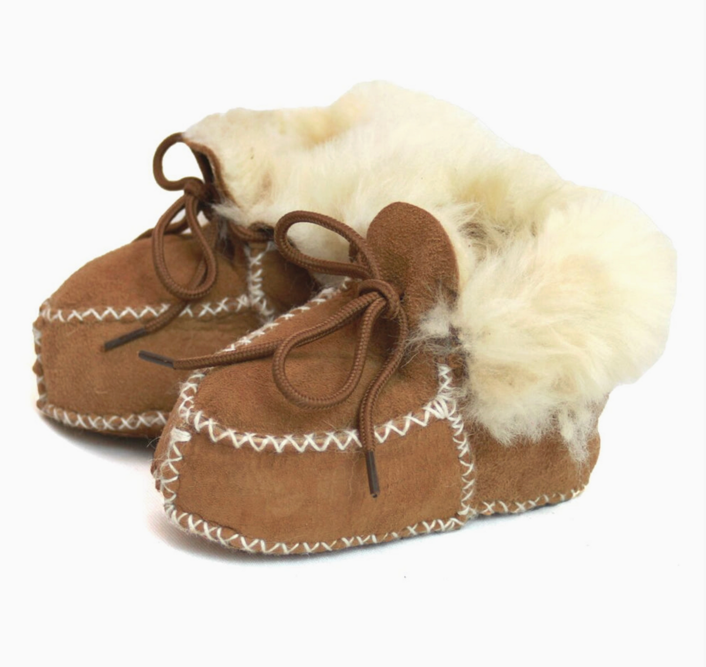 A pair of brown suede slipper boots with fluffy white shearling lining and white zigzag stitching, shown on a plain white background.