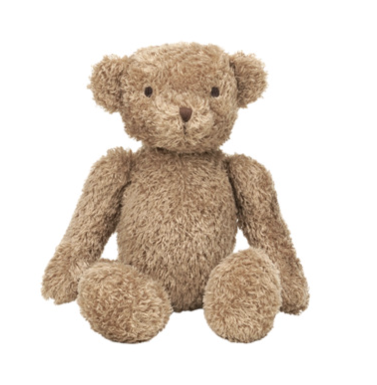 A classic plush teddy bear in a warm light brown or tan color, sitting upright against a solid white background.