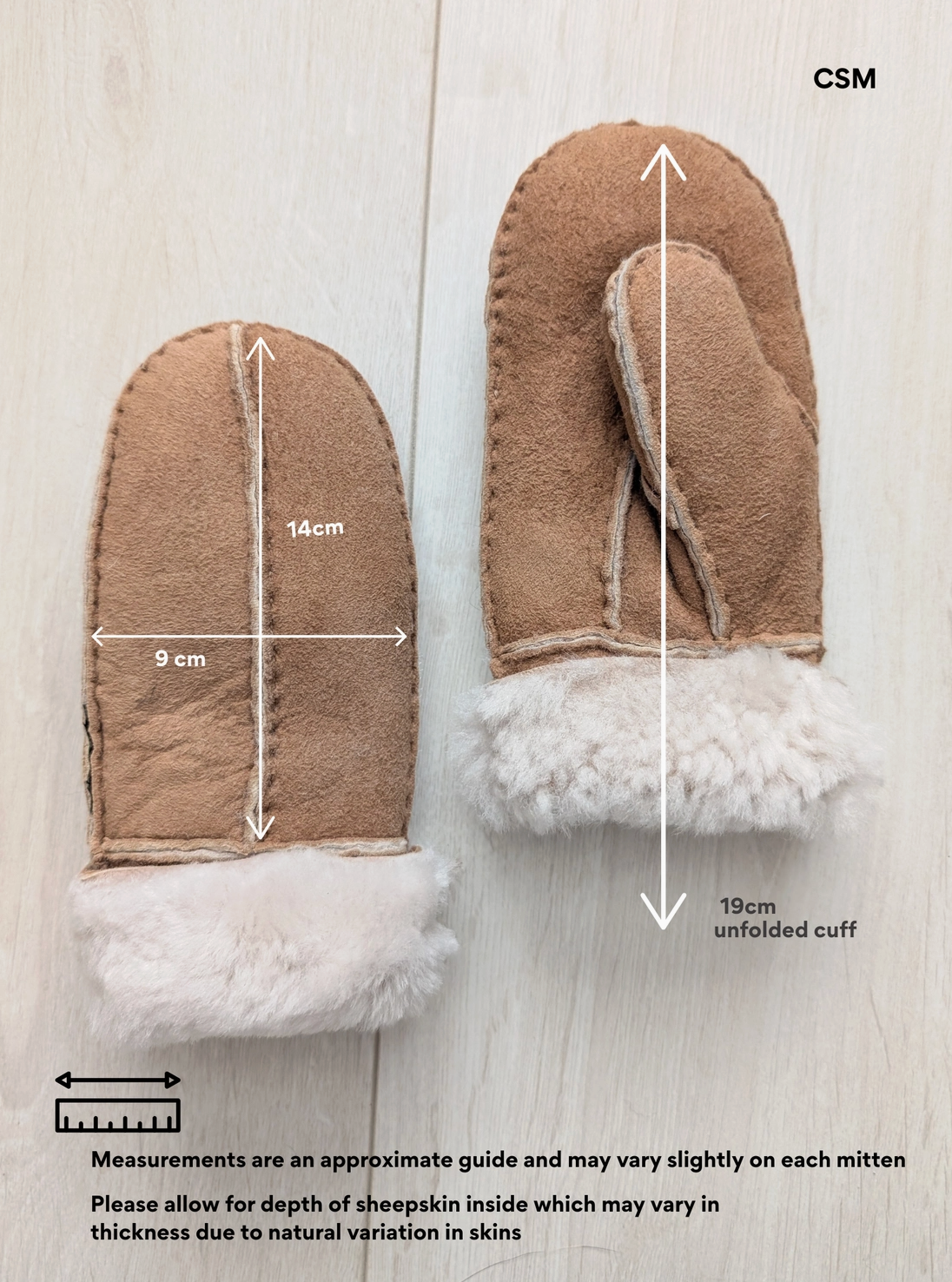 A pair of tan shearling-style mittens on a light wood background with overlaid dimension arrows and text showing measurements, including 14 cm width, 9 cm depth, and 19 cm unfolded cuff. The text notes measurements are approximate and may vary slightly.