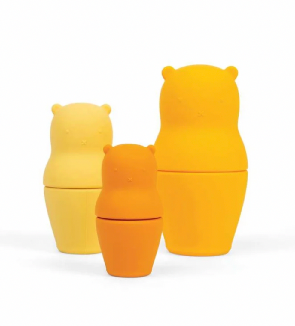 Three bear-shaped nesting containers in yellow, orange, and light yellow, arranged in a stack on a white background.