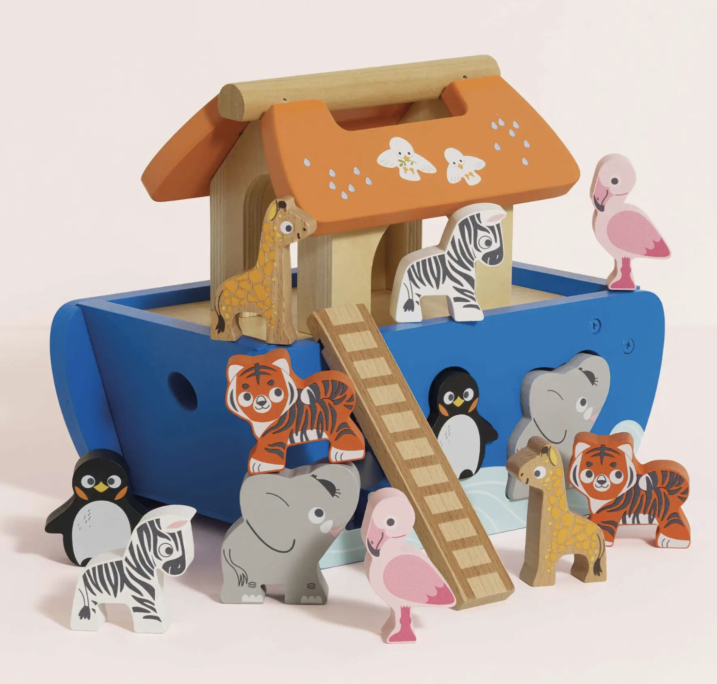 A wooden Noah's Ark toy set with a blue ark, orange roof, ladder, and painted animal figures including giraffes, zebras, tigers, penguins, elephants, flamingos, and a pink flamingo on a light beige background.